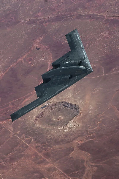 Inflight view of a USAF Northrop Grumman B-2A stealth bomber over the Barringer Meteor Crater in Arizona