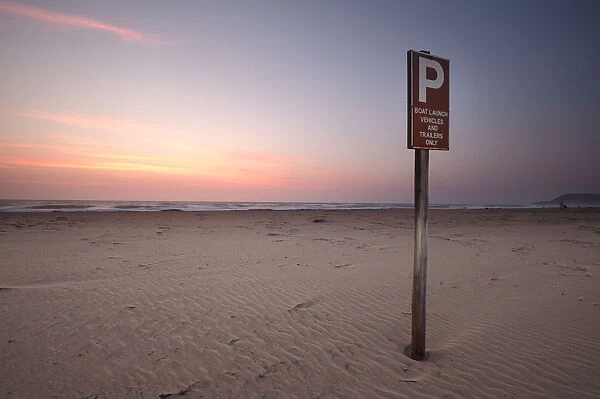 Information sign on beach at sunrise, Estuary Beach, St Lucia, Kwazulu-Natal, South Africa