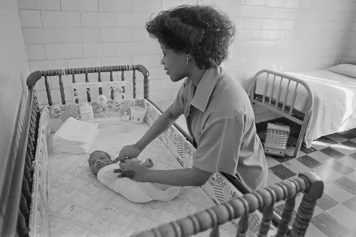 Framed Print : Inmate with Baby in Crib
