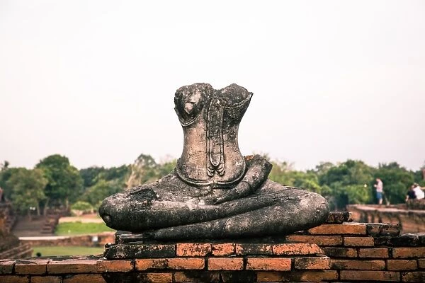 Isolated damaged buddha statue in Wat Chaiwatthanaram, Ayutthaya, Thailand