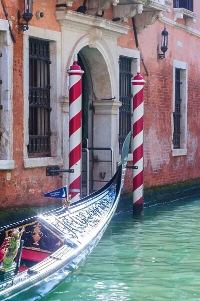 Italy, Veneto, Venice. View of a canal with gondola passing
