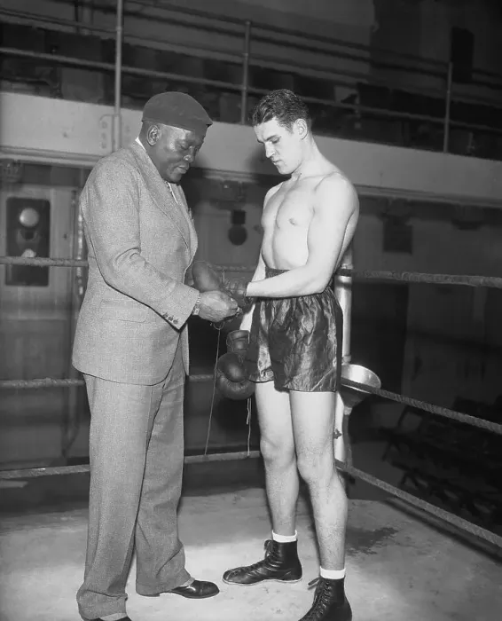 Framed Print : Jack Johnson Adjusting the Gloves of His Trainee Framed Print : Jack Johnson Adjusting the Gloves of His Trainee
