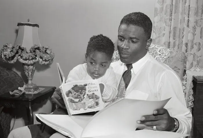 Framed Print : Jackie Robinson Reading Alongside His Young Son Framed Print : Jackie Robinson Reading Alongside His Young Son