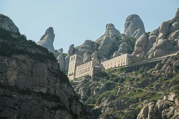 The jagged mountains in Catalonia with Cable Car (Aeri de Montserrat), Spain, showing the Benedictine Abbey at Montserrat, Santa Maria de Montserrat, near Barcelona