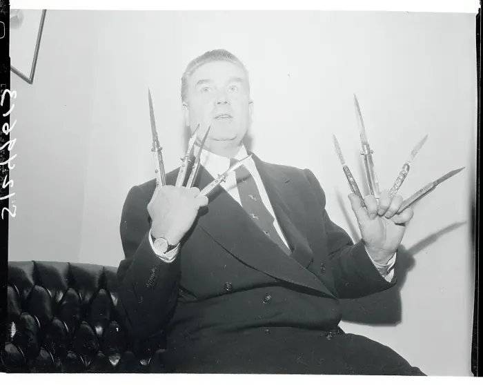 Framed Print : James Delaney Holding Switchblade Knives