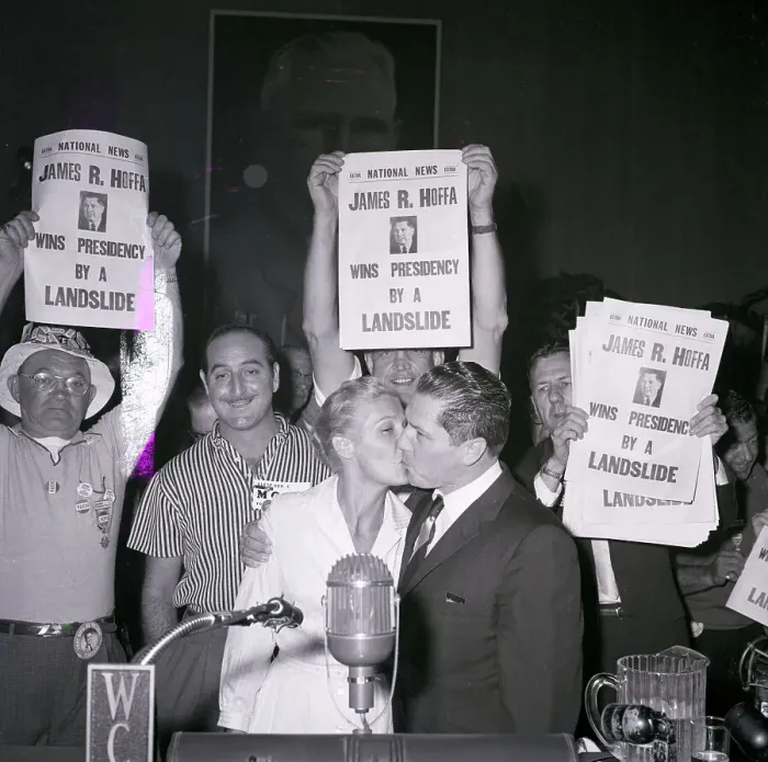 Framed Print : James Hoffa Kisses Wife Beneath Poster