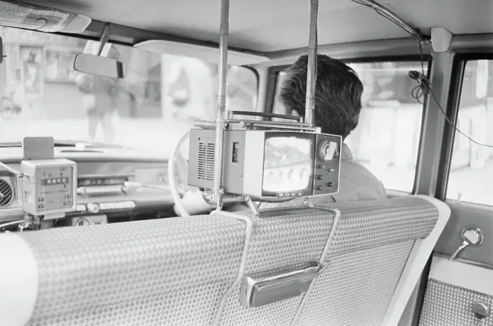 Framed Print : Japanese Taxi Customers Watch Television Framed Print : Japanese Taxi Customers Watch Television