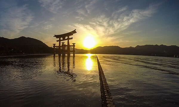 Japanese torii on the island of MiyaJima at sunset