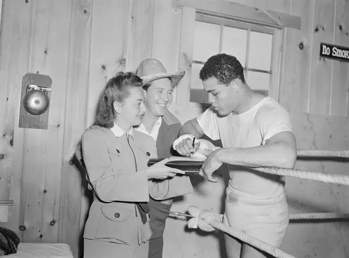 Framed Print : Joe Louis Signing Autograph for Olivia De Havilland Framed Print : Joe Louis Signing Autograph for Olivia De Havilland