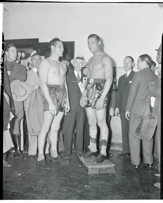 Framed Print : Joe Louis Standing on Scale Framed Print : Joe Louis Standing on Scale