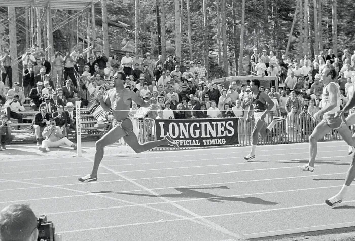 Framed Print : John Carlos Crossing Finish Line