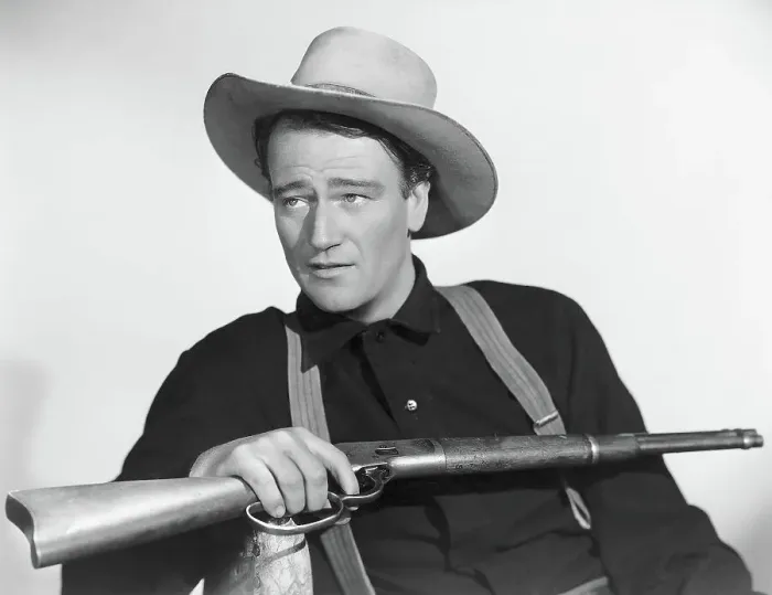 Framed Print : John Wayne Seated With Rifle