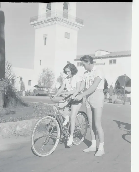 Framed Print : Johnny Weismuller Helping Lupe Velez on Bicycle Framed Print : Johnny Weismuller Helping Lupe Velez on Bicycle