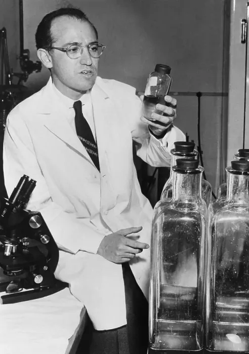Framed Print : Jonas Salk Holding Bottle in Laboratory Framed Print : Jonas Salk Holding Bottle in Laboratory
