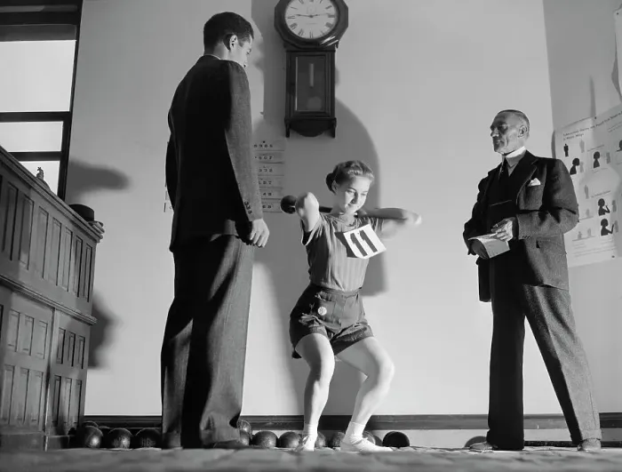 Framed Print : Judges Watch Woman Lift Weights