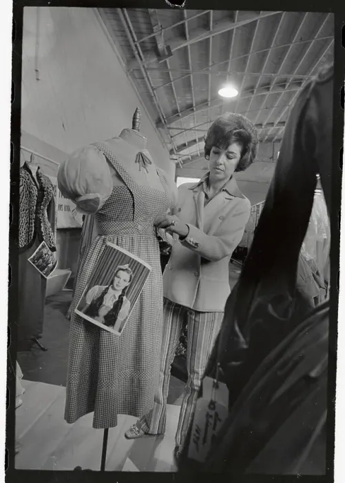 Framed Print : Judy Carroll Putting Tag on A Dress Framed Print : Judy Carroll Putting Tag on A Dress