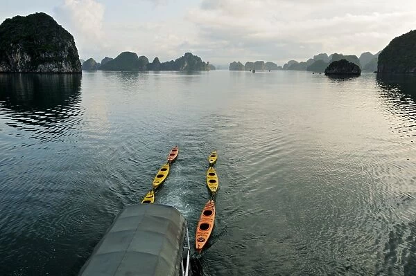 Kayaks pulled by a boat in Bai Tu Long - Ha Long bay - Vietnam