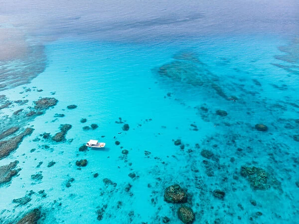 Kerama Islands National Park with clear tropical water and boat from above, Okinawa