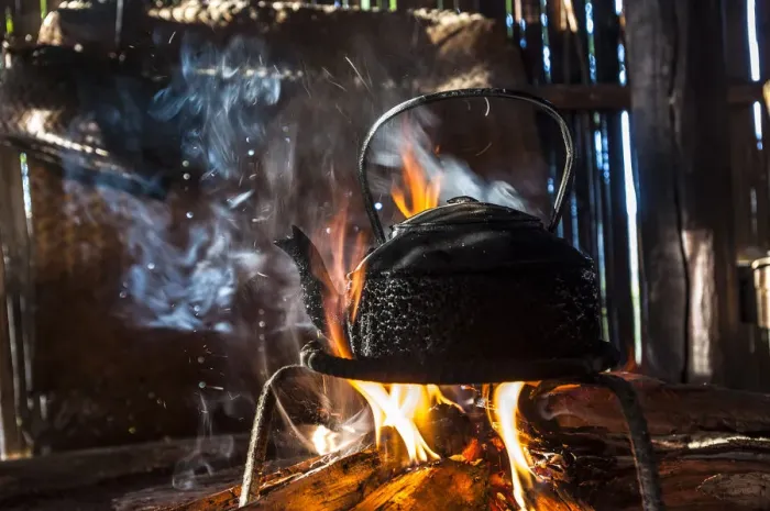 Framed Print : Kettle over an open fire in a kitchen made of bamboo, Lahu village, province of Mae Hong Song, Northern Thailand, Thailand