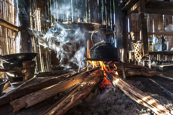 Kettle over an open fire in a kitchen made of bamboo, Lahu village, province of Mae Hong Song, Northern Thailand, Thailand