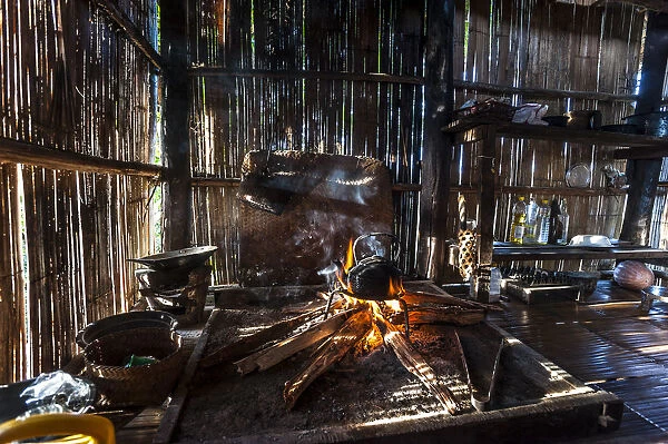 Kettle over an open fire in a kitchen made of bamboo, Lahu village, province of Mae Hong Song, Northern Thailand, Thailand