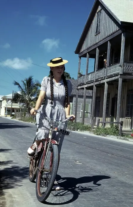 Framed Print : KEY WEST, FL - CIRCA 1946: A girl in a dress and straw hat rides her bike in Key West Framed Print : KEY WEST, FL - CIRCA 1946: A girl in a dress and straw hat rides her bike in Key West