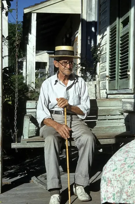 Framed Print : KEY WEST, FL - CIRCA 1946: A view as a old man sits with his cane in Key West, Florida Framed Print : KEY WEST, FL - CIRCA 1946: A view as a old man sits with his cane in Key West, Florida
