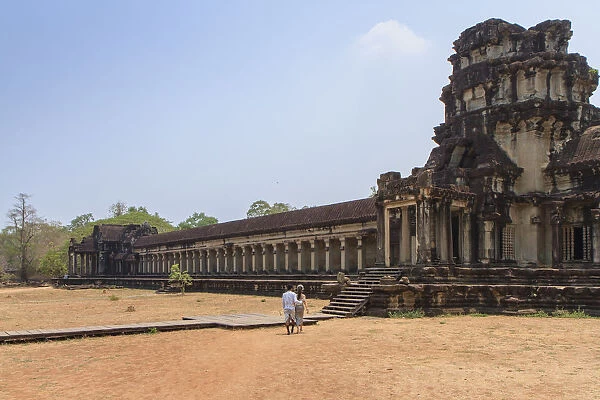 A Khmer couple from distance entering Angkor Wat Temple