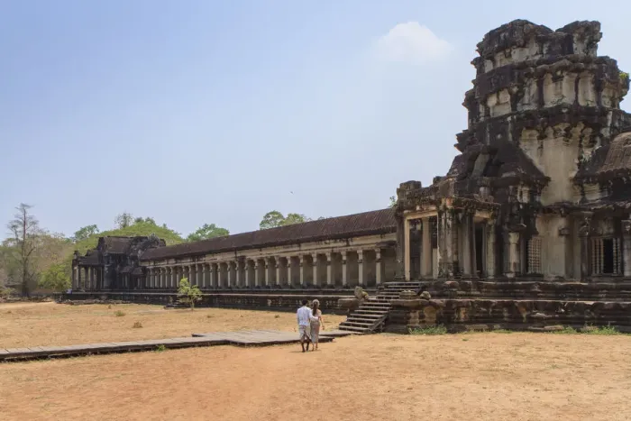 Framed Print : A Khmer couple from distance entering Angkor Wat Temple