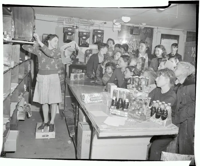 : Kids Drinking Coca Cola and Watching TV in Candy Shop : Kids Drinking Coca Cola and Watching TV in Candy Shop