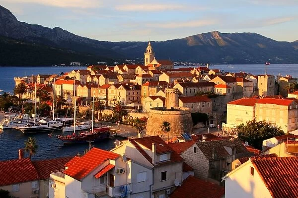 Korcula, view of the fortified town by the sea at sunset, Dalmatia, Croatia