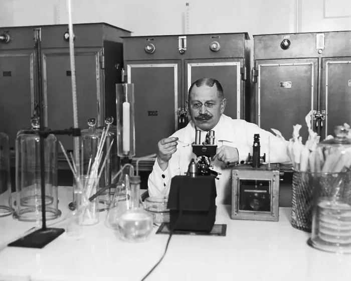 Framed Print : Lab Tech Examining Slide At Microscope Framed Print : Lab Tech Examining Slide At Microscope