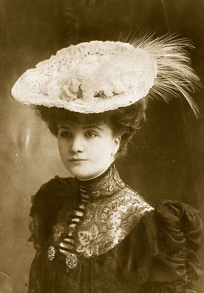 Lacey Hat. circa 1905: An Edwardian white lace hat with feather trimming