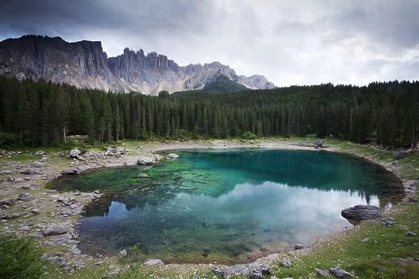 Lake Carezza with Latemar Mountain with clouds, Karerpass, Dolomiten, South Tyrol province, Trentino-Alto Adige, Italy