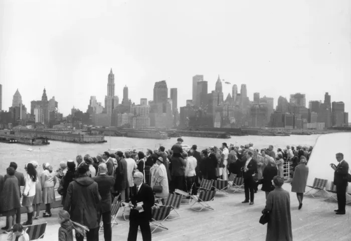 Framed Print : Landfall. Passengers on the QE2 line the rails as the ship arrives in New York