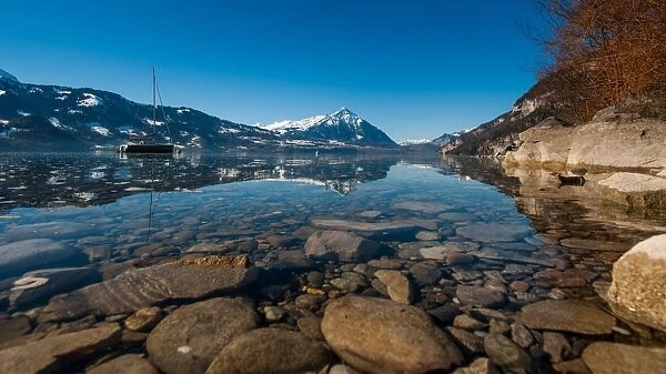 Landscape view of lake Thun with reflection in water