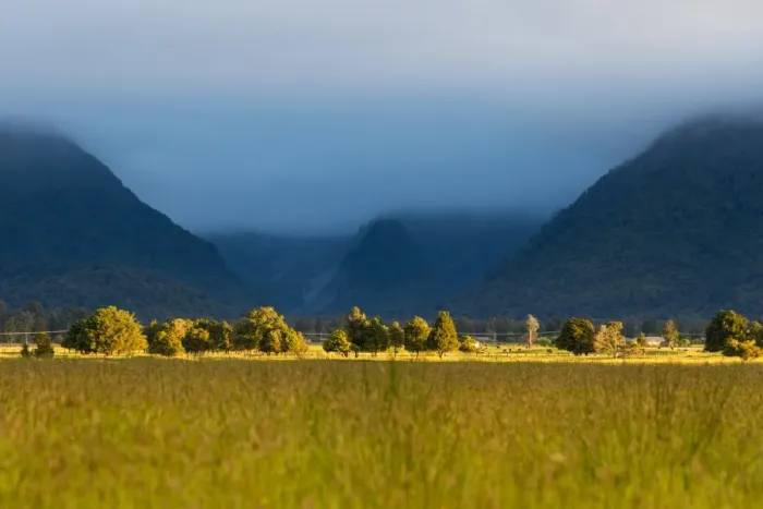 Framed Print : Landscape of green meadow and mountain range Framed Print : Landscape of green meadow and mountain range