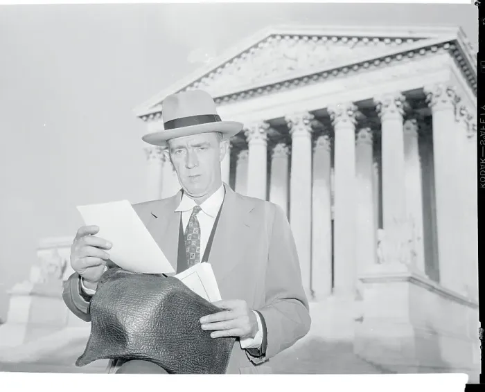 Framed Print : Lar. J. Daly Reading in Front of Building Framed Print : Lar. J. Daly Reading in Front of Building