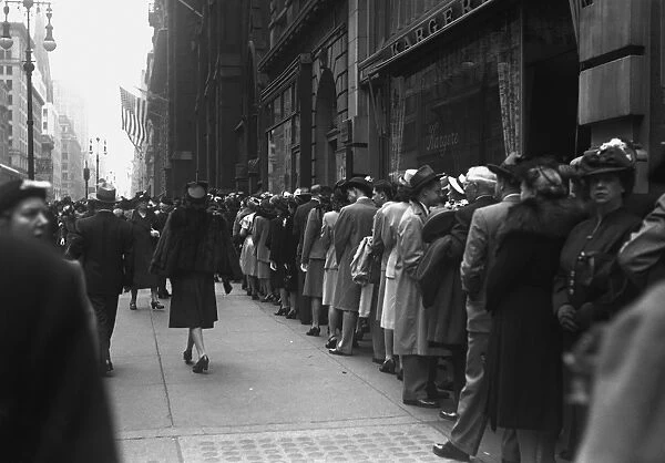 Large group of people waiting in line outdoors, (B&W)
