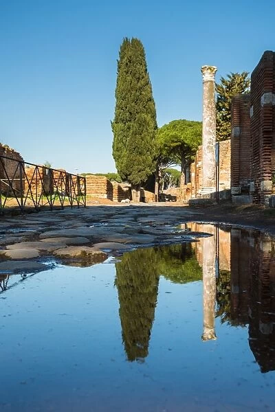 A large puddle in the ruins of the Ancient Roman harbour city of Ostia Antica in Rome, Italy