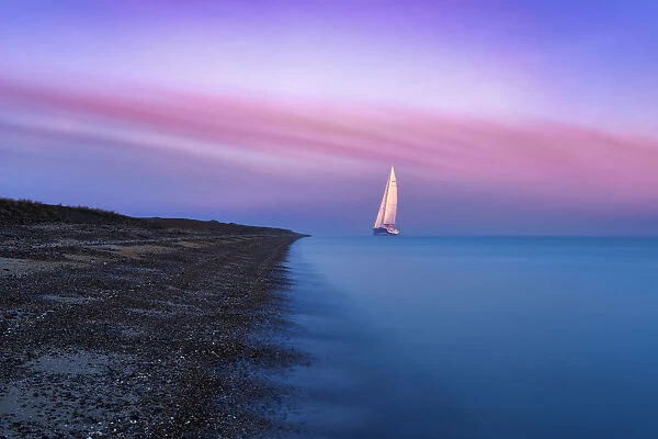 A large sailing boat of the Isle of Sheppey at sunrise, Kent. UK