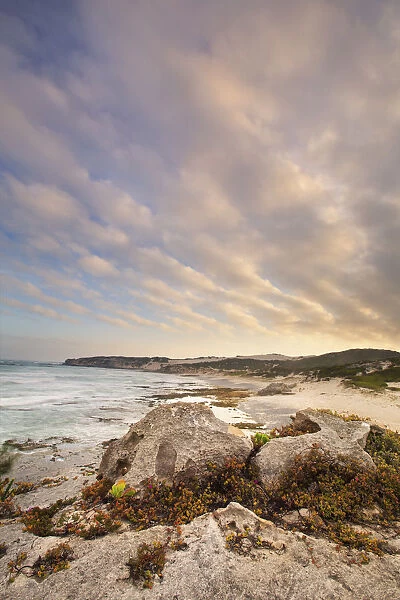 Late evening landscape of ocean over rocky shore with heavy clouds blowing in - Arniston South Africa
