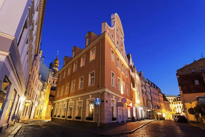 Framed Print : Latvia, Riga, Corner of illuminated building against blue dusk sky Framed Print : Latvia, Riga, Corner of illuminated building against blue dusk sky