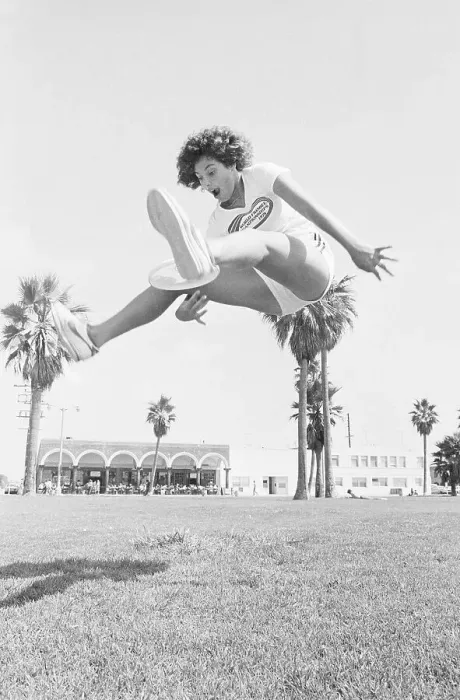 Framed Print : Laura Engel Catching Frisbee Through Her Legs