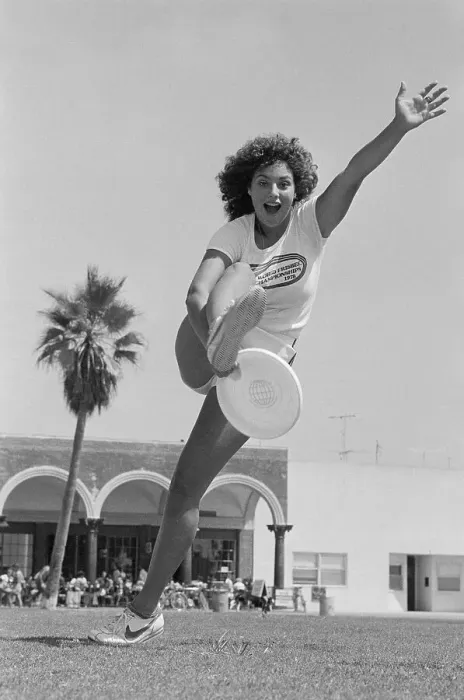 Framed Print : Laura Engel Catching Frisbee Through Her Legs