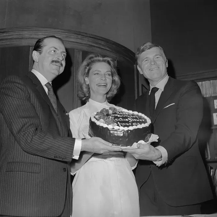 Framed Print : Lauren Bacall Holding a Birthday Cake with Colleagues Framed Print : Lauren Bacall Holding a Birthday Cake with Colleagues