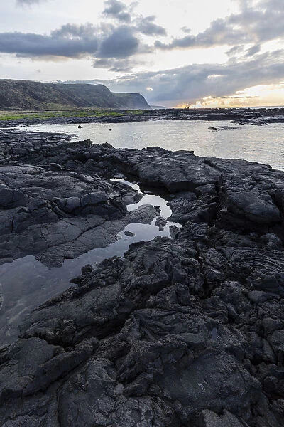 Lava rock shoreline at sunrise, Hawaii, USA