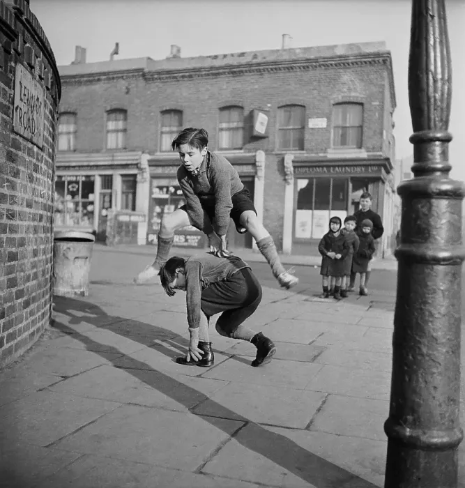 Framed Print : Leap Frog. A group of children playing leap frog in the street Framed Print : Leap Frog. A group of children playing leap frog in the street