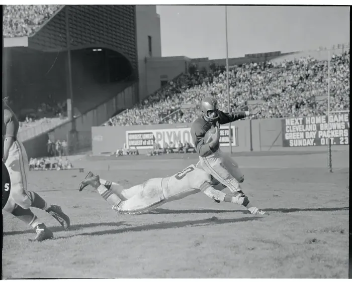 Framed Print : Len Ford Tackling His Opponent