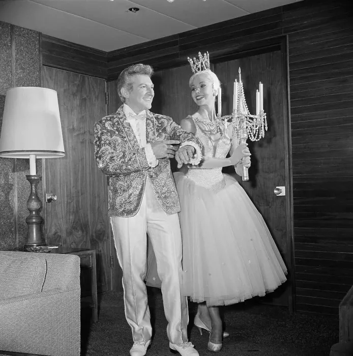 Framed Print : Liberace Showing off Jacket to Showgirl Framed Print : Liberace Showing off Jacket to Showgirl